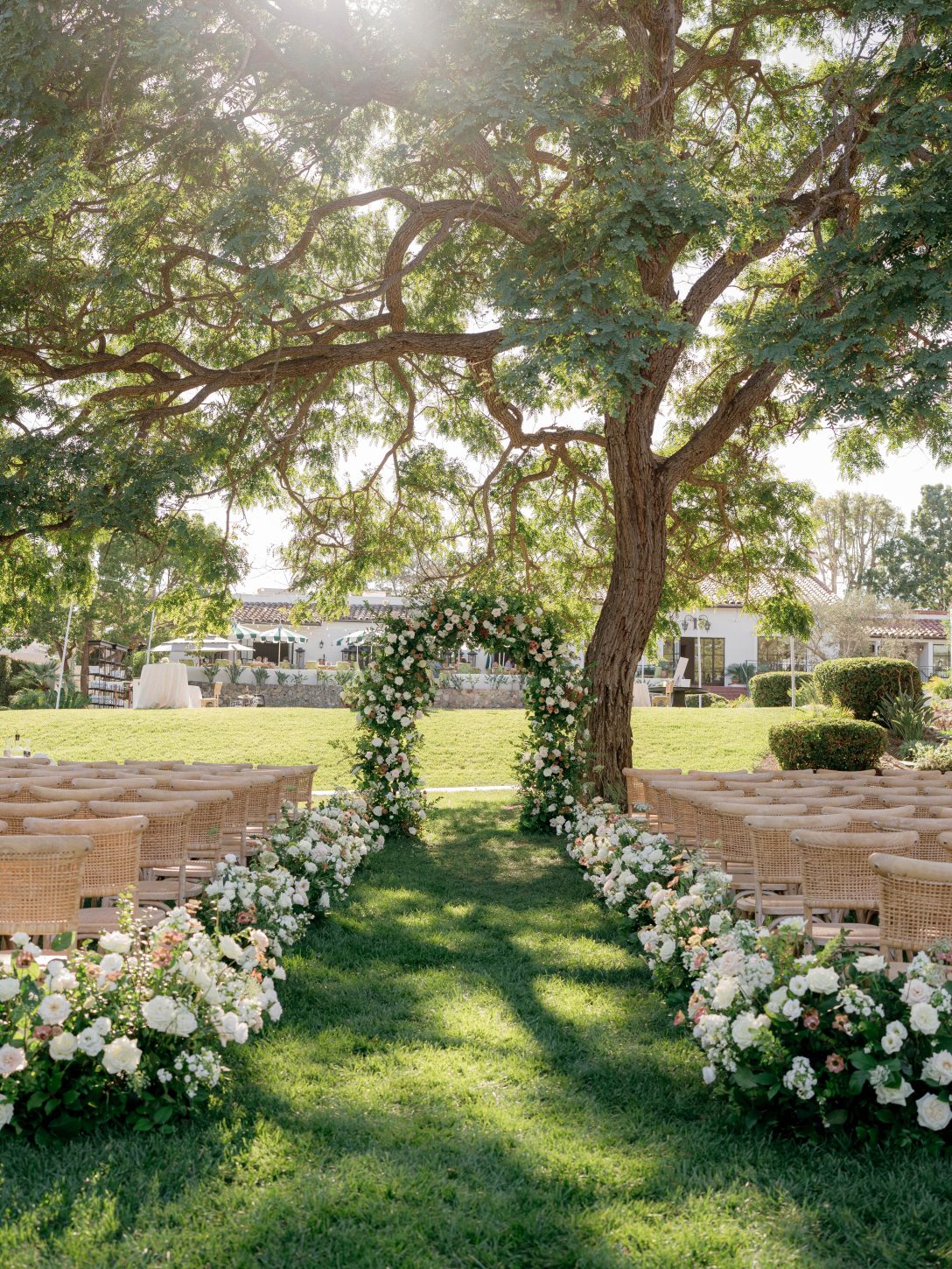 Wedding decoration in the garden of The Inn at Rancho Santa Fe with an altar at the end.